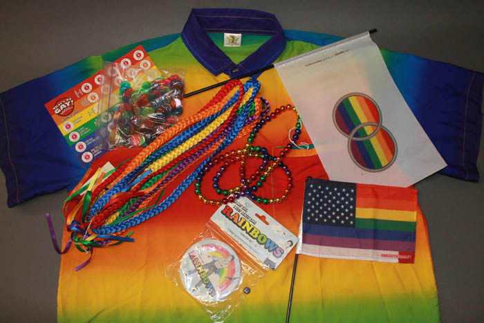 Miscellaneous objects from the museum’s collection that feature rainbows, including “That’s So Gay!” trivia game, coasters, and flags promoting marriage equality and immigration equality