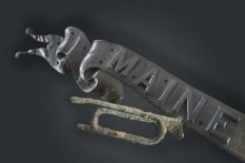 Metal encrusted bugle with "Maine"